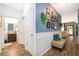Hallway with wainscoting and framed art, with bathroom and living room visible at 16379 Blooming Cherry Dr, Groveland, FL 34736