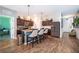 Spacious kitchen with granite island, stainless steel appliances, dark wood cabinetry, and wood flooring at 16379 Blooming Cherry Dr, Groveland, FL 34736