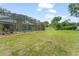 Expansive backyard featuring a screened pool area with lush green space for outdoor activities at 17523 Doris St, Montverde, FL 34756