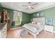 Bedroom featuring terracotta floors, a ceiling fan, and a comfortably made bed at 17523 Doris St, Montverde, FL 34756