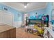 Bright bedroom with blue walls, a bunk bed, and tile floors at 17523 Doris St, Montverde, FL 34756