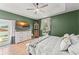 Comfortable bedroom featuring terracotta floors, a ceiling fan, a dresser, and a doorway to the outside at 17523 Doris St, Montverde, FL 34756