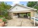 Spacious carport with a boat, golf cart and access to the lush backyard at 17523 Doris St, Montverde, FL 34756