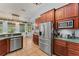 Bright kitchen with stainless steel appliances, tile floors, and wood cabinetry at 17523 Doris St, Montverde, FL 34756