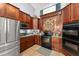 Efficient kitchen with stainless steel appliances, tile floors, and ample storage at 17523 Doris St, Montverde, FL 34756