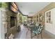 A covered outdoor patio features a brick fireplace, dining area, and views of the backyard at 17523 Doris St, Montverde, FL 34756