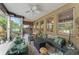 Inviting covered patio featuring cozy seating, stylish decor, and tranquil views at 17523 Doris St, Montverde, FL 34756