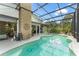 Inviting pool with a screened enclosure, outdoor lighting and a connecting patio at 17523 Doris St, Montverde, FL 34756