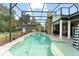 Sparkling private pool with screened enclosure, outdoor fireplace and sun loungers at 17523 Doris St, Montverde, FL 34756