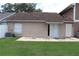 Backyard and home exterior featuring lawn and sliding glass doors at 1827 Blaine Ter, Winter Park, FL 32792