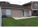 View of the backyard with sliding glass doors to patio and lawn at 1827 Blaine Ter, Winter Park, FL 32792