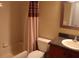 Cozy bathroom featuring a shower-tub combo with stylish shower curtain and vanity with granite countertop at 1827 Blaine Ter, Winter Park, FL 32792
