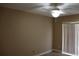 Tan bedroom with a ceiling fan, vertical blinds on a sliding glass door to patio or balcony at 1827 Blaine Ter, Winter Park, FL 32792