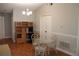Bright dining area with a glass table, seating for four, and a built-in workspace with natural wood cabinets at 1827 Blaine Ter, Winter Park, FL 32792