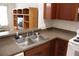 Kitchen with a stainless steel sink, wooden cabinets, and neutral countertops at 1827 Blaine Ter, Winter Park, FL 32792