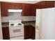 Kitchen with wooden cabinets, white appliances, and neutral countertops at 1827 Blaine Ter, Winter Park, FL 32792