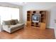Cozy living room featuring hardwood floors, a comfortable sofa, and a built-in entertainment center at 1827 Blaine Ter, Winter Park, FL 32792