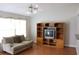 Inviting living room features hardwood floors, a cozy couch, and a built-in entertainment center at 1827 Blaine Ter, Winter Park, FL 32792