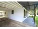 Exterior view of home featuring a covered carport and shaded front porch at 1975 Waldo St, Orlando, FL 32806