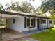 Charming home with grey exterior paint, dark shutters, and wrought iron porch railing at 1975 Waldo St, Orlando, FL 32806
