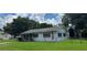 Quaint single-story home with dark shutters, well-maintained lawn, and a flagpole with an American flag at 1975 Waldo St, Orlando, FL 32806