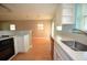 Well-lit kitchen leading into the living area with laminate floors and neutral tones at 1975 Waldo St, Orlando, FL 32806