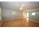 Open-concept living area with hardwood floors, ceiling fans and natural light from multiple windows at 1975 Waldo St, Orlando, FL 32806