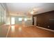 Spacious living room with laminate flooring, ceiling fan, and bright kitchen view at 1975 Waldo St, Orlando, FL 32806