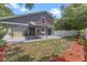 Backyard featuring patio with sun shade and landscaped areas at 202 Ferryboat Ct, Orlando, FL 32828