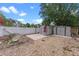 Spacious backyard featuring a patio, storage sheds, and a white privacy fence at 202 Ferryboat Ct, Orlando, FL 32828