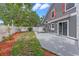 Gray house featuring a back patio and partially grassed backyard at 202 Ferryboat Ct, Orlando, FL 32828