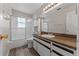 Bright bathroom with wood-look flooring, white vanity, neutral walls, and a shower-tub combination at 202 Ferryboat Ct, Orlando, FL 32828