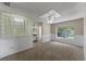 Bedroom with carpet, white wainscoting, and view of the backyard at 202 Ferryboat Ct, Orlando, FL 32828