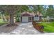 Charming single-Gathering home with well-maintained landscaping, a driveway, and a welcoming front entrance at 202 Ferryboat Ct, Orlando, FL 32828