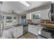 Kitchen with stainless steel appliances, granite countertops, and window views at 202 Ferryboat Ct, Orlando, FL 32828