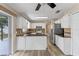 Open kitchen layout with white cabinets, granite counters, stainless appliances, and seamless flow to outdoor patio at 202 Ferryboat Ct, Orlando, FL 32828