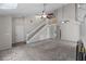 Bright living room with soaring ceilings, a staircase, and neutral carpeting creating a comfortable space at 202 Ferryboat Ct, Orlando, FL 32828