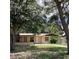 Traditional single-story home featuring a well-manicured front yard with a brick-paved driveway and mature landscaping at 2023 Messina Ave, Orlando, FL 32811