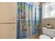 Bright bathroom featuring a patterned shower curtain at 2132 Palm Vista Dr, Apopka, FL 32712