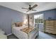 Charming bedroom with floral wallpaper, a four-poster bed, and a decorative ceiling fan at 2132 Palm Vista Dr, Apopka, FL 32712