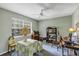 Bedroom features a table with a patterned tablecloth and a ceiling fan at 2132 Palm Vista Dr, Apopka, FL 32712