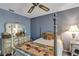 Bedroom featuring four poster bed, floral wallpaper, and vintage white dresser at 2132 Palm Vista Dr, Apopka, FL 32712