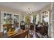 Light-filled dining area features a wood-burning stove and French doors opening to the outdoors at 2132 Palm Vista Dr, Apopka, FL 32712