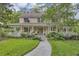 Charming two-story home with a welcoming front porch and beautiful landscaping at 2132 Palm Vista Dr, Apopka, FL 32712