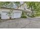 Charming two-story home featuring an attached two car garage, large driveway, and inviting front porch at 2132 Palm Vista Dr, Apopka, FL 32712