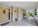 Covered front porch with decorated door and serene seating area at 2132 Palm Vista Dr, Apopka, FL 32712