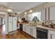Traditional kitchen with white cabinets, black appliances and hardwood floors at 2132 Palm Vista Dr, Apopka, FL 32712