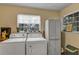 Laundry room with white washer and dryer and storage cabinet at 2132 Palm Vista Dr, Apopka, FL 32712