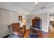 Cozy living area featuring an armchair, side table with lamp, and wood floors at 2132 Palm Vista Dr, Apopka, FL 32712