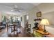 Bright living area featuring wood floors, a ceiling fan, and windows at 2132 Palm Vista Dr, Apopka, FL 32712